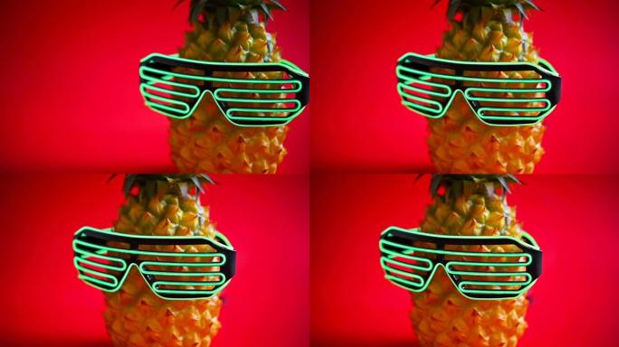 侧盘视图菠萝戴着发光二极管眼镜