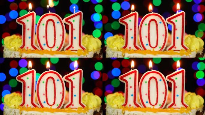 101号生日快乐蛋糕与燃烧的蜡烛顶。