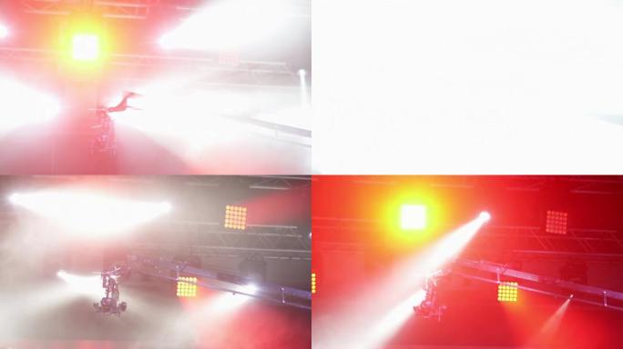 聚光灯背景下起重机上的摄像机。从上方拍摄音乐会