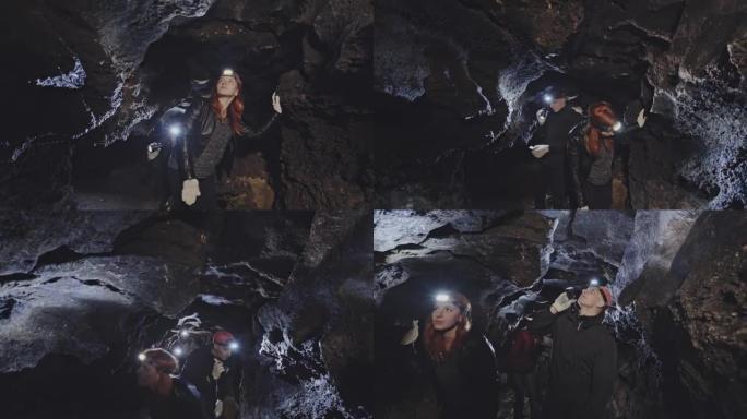一群洞穴学家走过岩石洞穴