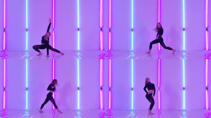 苗条的舞者在明亮的霓虹灯的背景下表演了性感的现代蔑视和有氧元素。女性在黑暗工作室练习现代舞蹈。慢动作