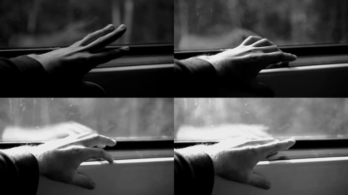 一个人坐火车，用手指在窗台上轻拍。不错的特写镜头。