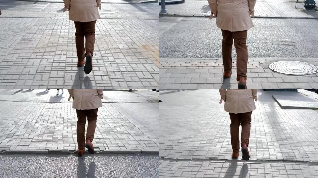 一个男人沿着街道走了很长，自信的步伐。特写步骤。慢动作