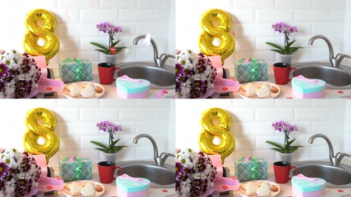 厨房里的五彩纸屑，配有金色气球、礼品盒和母亲节鲜花。3月8日国际妇女节