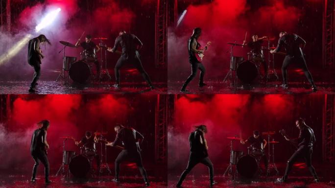 相机在一群摇滚音乐家身上滑动，他们在红灯照亮的黑暗工作室中以疯狂的情绪演奏乐器。鼓组、电吉他和贝司吉