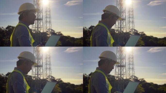 在笔记本电脑上工作的电信工程师记录数据以进行维护