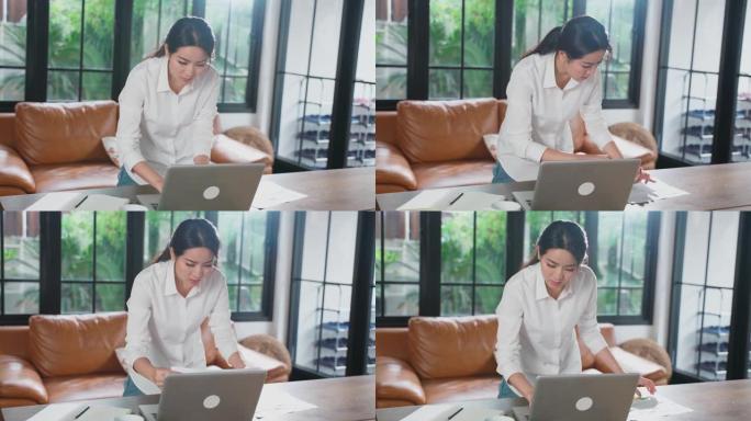亚洲年轻女性在家工作时使用笔记本电脑、耳机与办公室同事在线会面。女孩避免社交距离密切接触者人保护，防