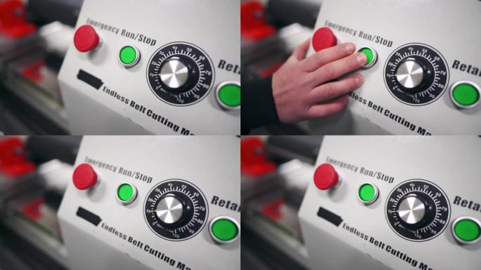 在工厂中，人手按下开始按钮的特写