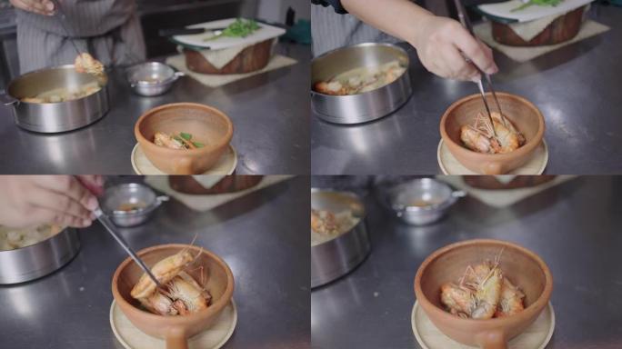SLO MO: 厨师的手将汤姆百胜汤锅中的虾放入陶罐中。