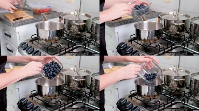 女人将蓝莓倒入锅中制作果酱。