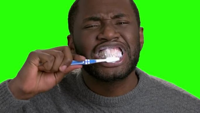 皮肤黝黑的男人刷牙。