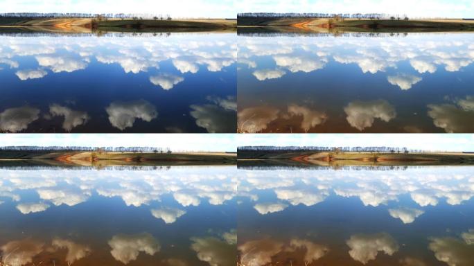 云彩反映在湖泊的光滑水中，4k