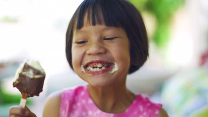 可爱的女孩正在吃巧克力冰淇淋零食，带着积极的情绪，放松和享受饮食。