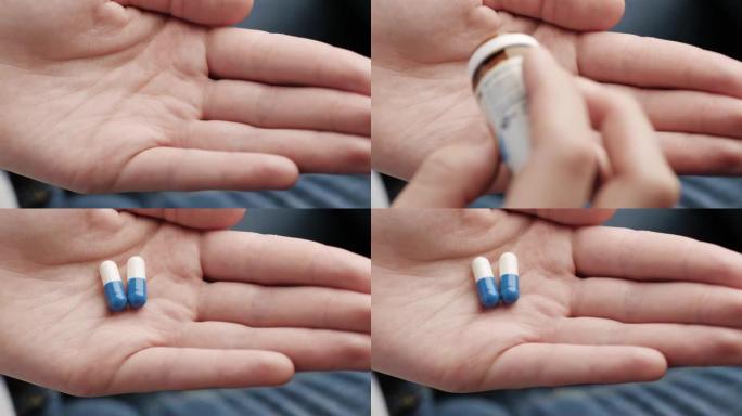 两个大的白蓝色圆柱形胶囊从药瓶中落入手掌。特写，顶视图