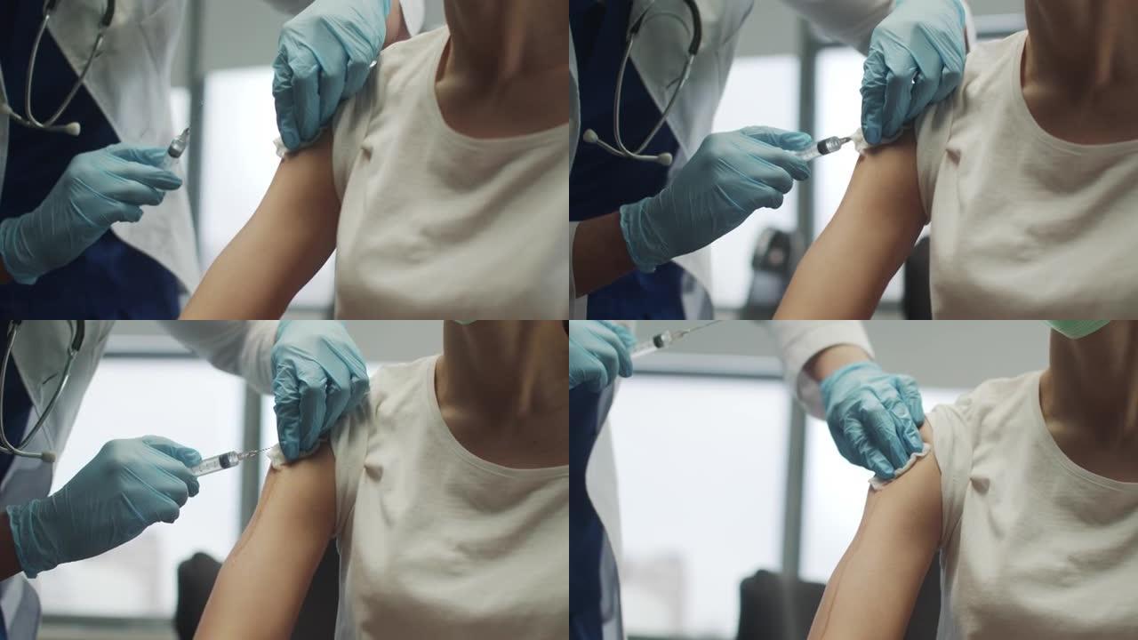 患者在手臂上接受了针对okved-19病毒菌株的疫苗接种。医生用酒精润滑手注射