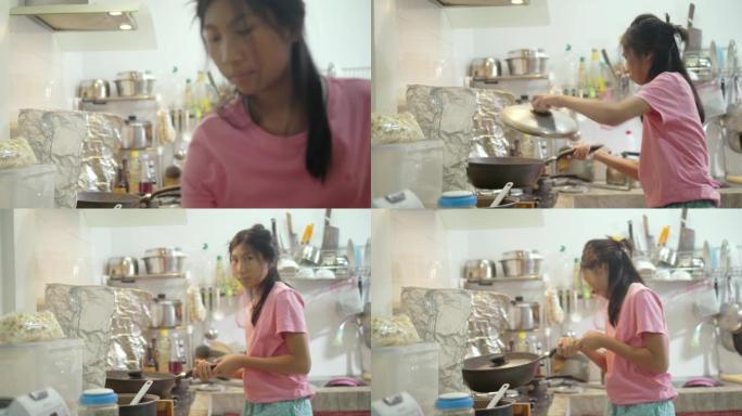 亚洲女孩在家厨房里自己做爆米花，生活方式理念。