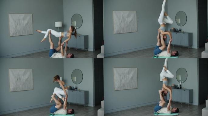 瑜伽情侣练习。一对年轻的运动人士在瑜伽运动中与伴侣，男人和女人一起练习杂技瑜伽课，使身体保持平衡变得