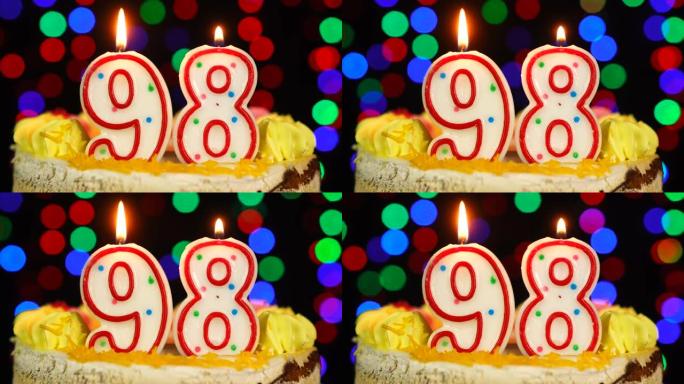 98号生日快乐蛋糕Witg燃烧蜡烛礼帽。