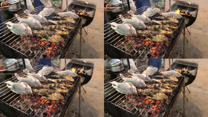 在火炉上用草药烤鱼，泰国的街头食品。