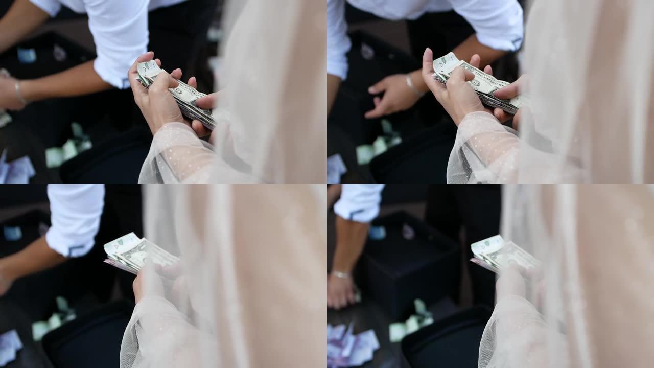 一个年轻女孩的手，她拿着很多来自不同国家的钞票