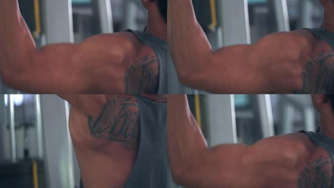 亚洲男子使用背部肌肉训练机