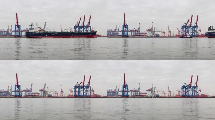集装箱船在深海港的装卸，商业物流的低角度视图集装箱船的进出口货物运输，集装箱装载货物的货运船，时间流