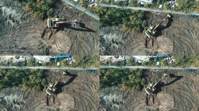 清理和调水区域的挖掘机顶部工作的鸟瞰图。挖掘机进行大地测量。平整未来湖的底部