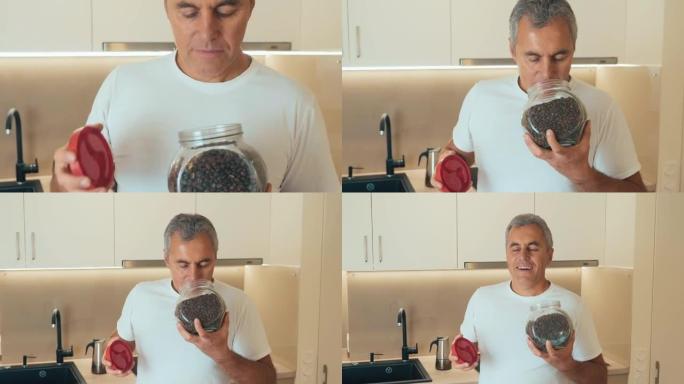 Middle aged man holds a jar of coffee beans. Jar o