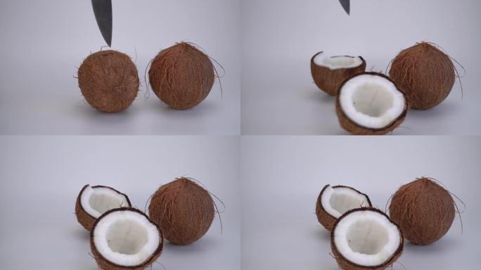 椰子用刀分成两部分。可可，成熟的棕榈果。坚果是有用的，改善身体在许多疾病的状况。