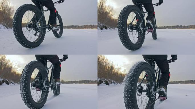 专业极限运动员骑自行车的人在户外骑胖自行车。后轮的特写视图。骑自行车的人在冬季森林里骑自行车。骑着大