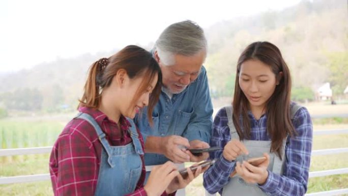 4k两个亚洲女儿用智能手机教高级父亲