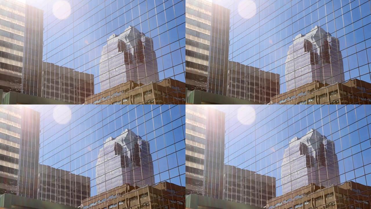 蒙特利尔办公室摩天大楼在玻璃墙上的倒影，手持镜头耀斑