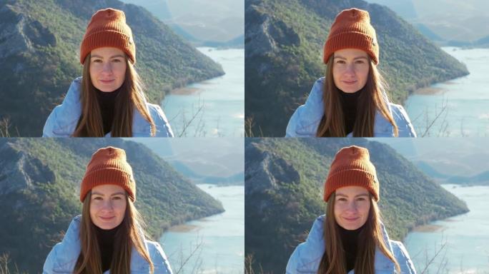 橙色帽子上的美女肖像，背景上有阳光和峡谷