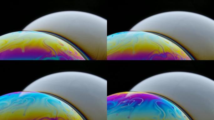 肥皂泡宏彩虹色创造五彩图案。彩色泡沫肥皂泡慢动作。与其他星系行星非常相似。特写