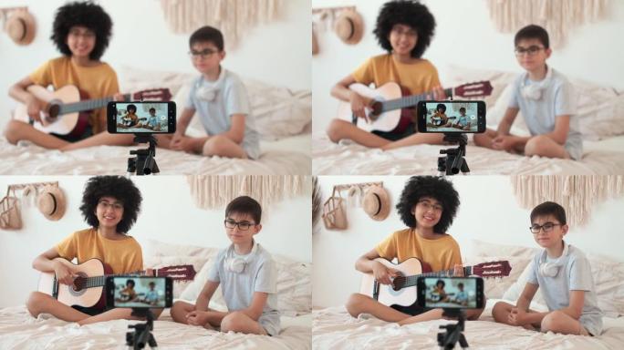 儿童博客作者在智能手机上录制吉他课程