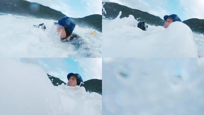 冲浪摄影师。戴着蓝色帽子的男人带着动作相机在波涛汹涌的大海中游泳
