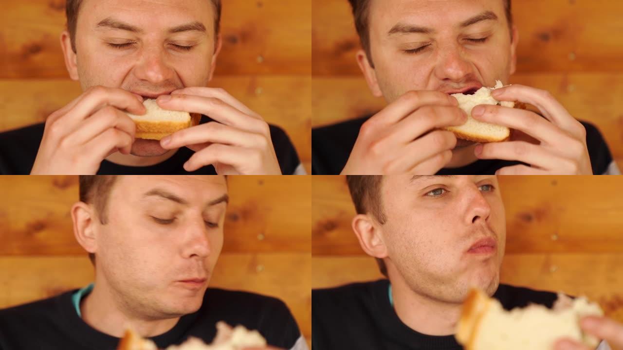 一个人咬着吃白面包做的三明治。