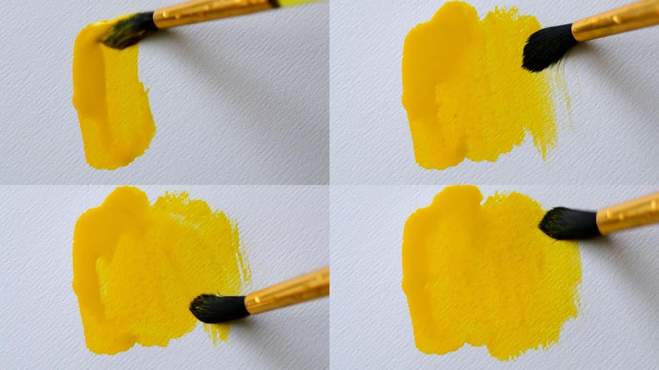 男人艺术家用黄色油漆水彩的笔触绘画