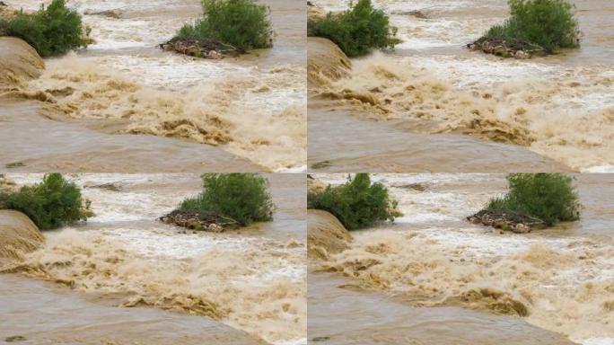 春季大雨期间洪水泛滥的肮脏河流。