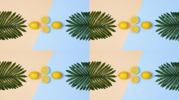 富有创意的热带棕榈叶和新鲜的柑橘柠檬出现在蓝色的沙质背景上。夏季热带停止运动flay lay