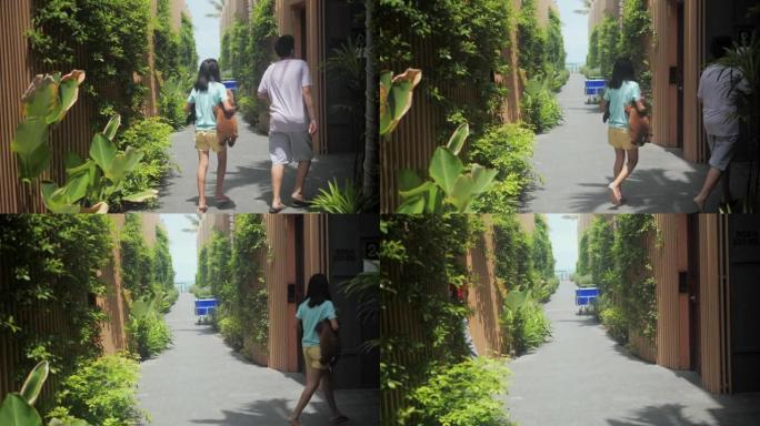 孩子们在阳光明媚的日子走在去酒店房间的路上，暑假的概念。