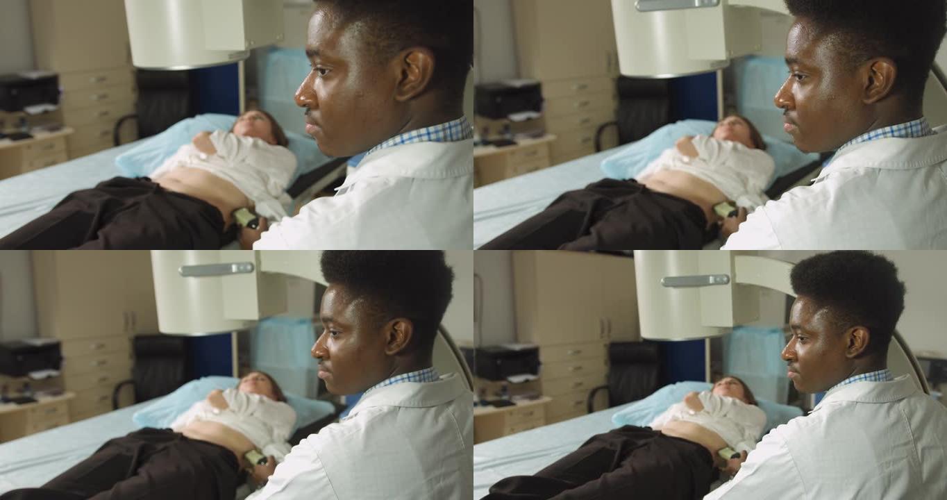 现代中心肾结石和输尿管结石碎石术。专业的非洲男子医生，使用超声波扫描为其女性患者在碎石前确定结石位置