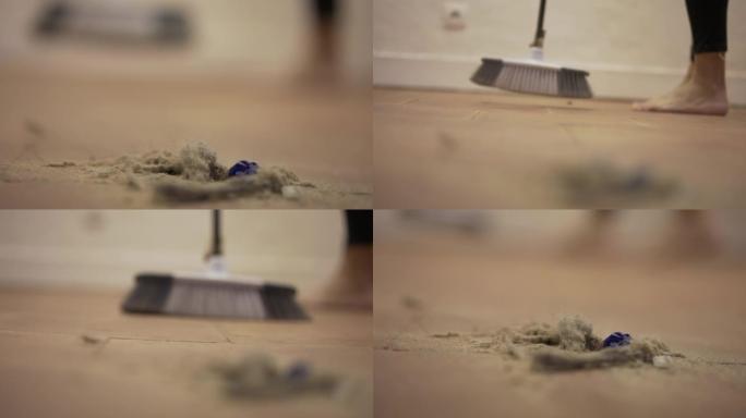 地板上的脏灰尘，用扫帚扫地