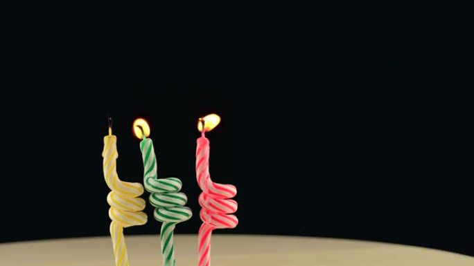 三个生日蜡烛的镜头在黑暗的背景下闪电，3年。