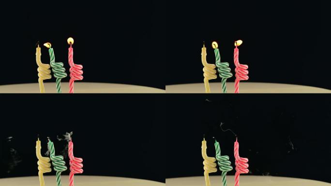 三个生日蜡烛的镜头在黑暗的背景下闪电，3年。