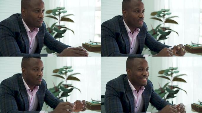 非裔美国人穿西装视频通话，与多种族教练、员工在线会议。