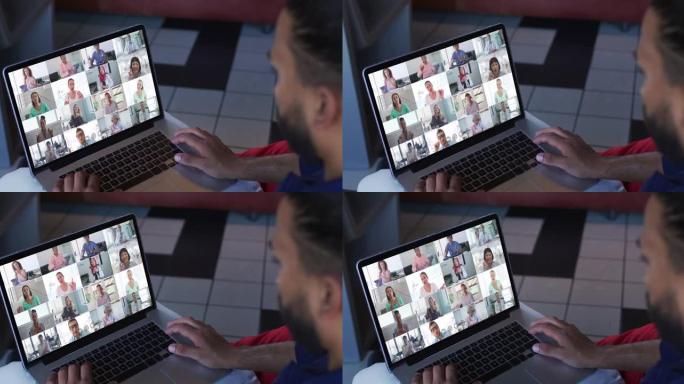 非裔美国人与办公室同事在家里的笔记本电脑上进行视频会议