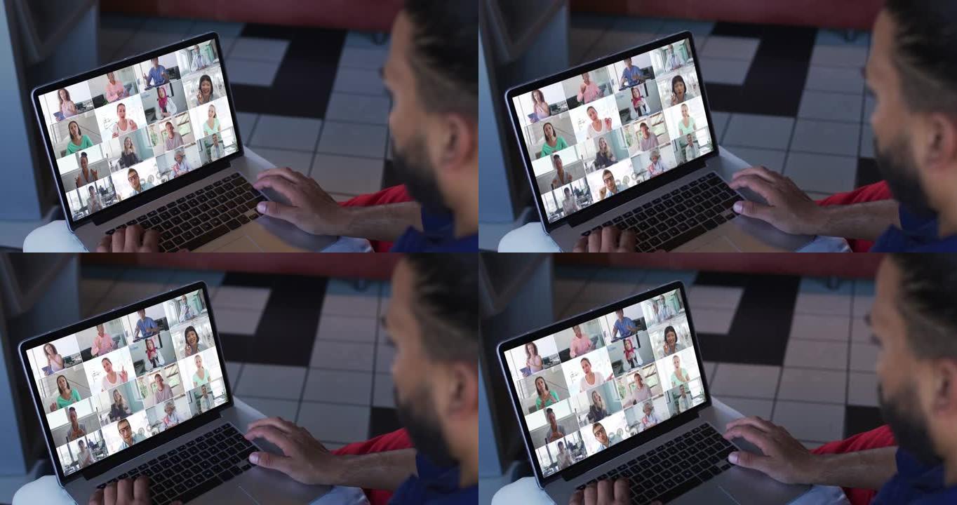 非裔美国人与办公室同事在家里的笔记本电脑上进行视频会议