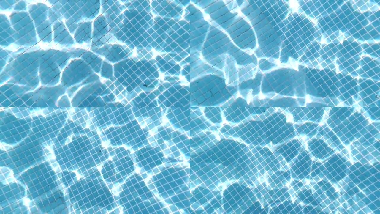 纯蓝的水在池中与光反射。从空旷的蓝色游泳池的水下观看。