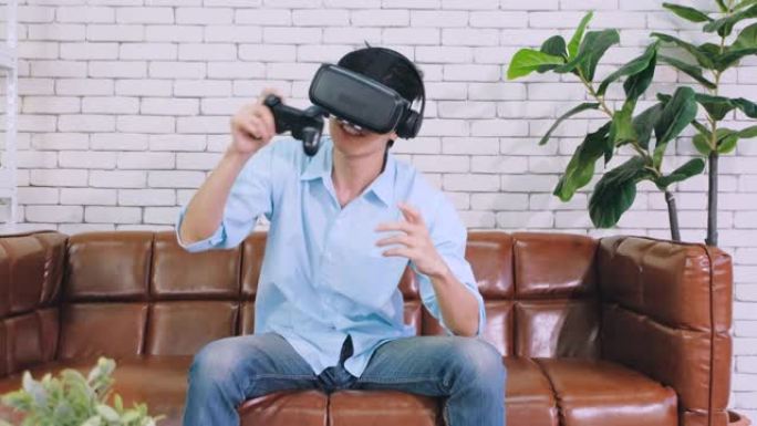亚洲男子戴VR眼镜玩虚拟现实耳机玩电子游戏输球时心烦意乱